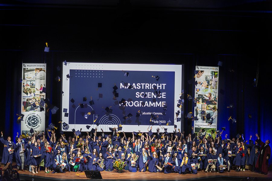 The class of 2023 filling the auditorium with caps