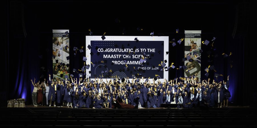 A dense cloud of caps above the class of 2024